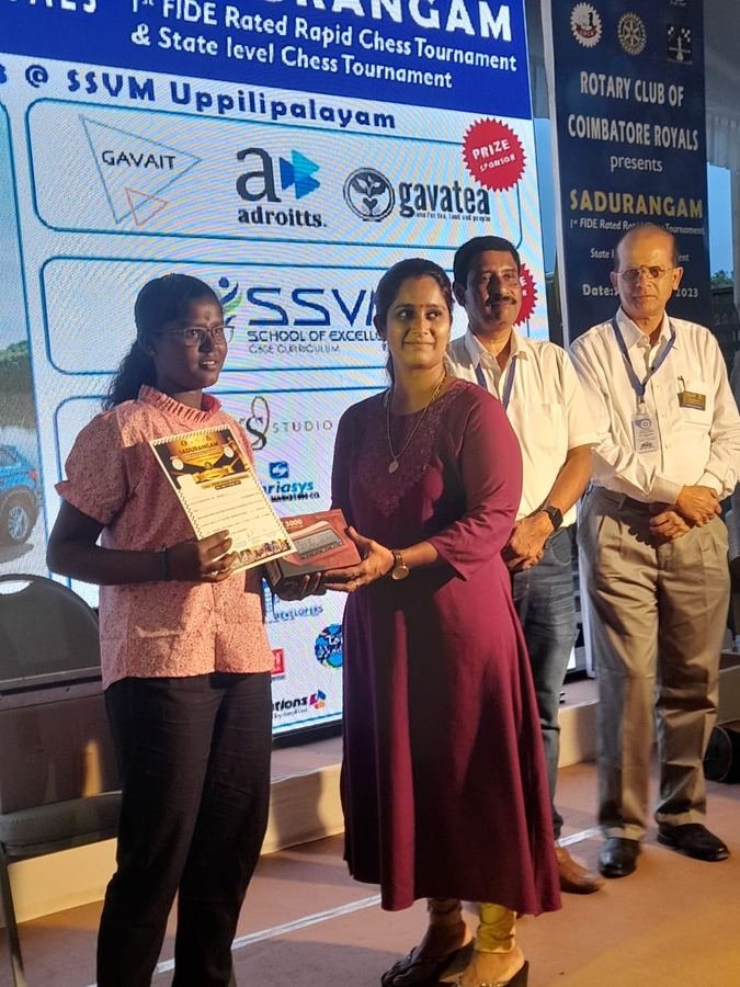 Student receiving award at Sadurangam 1st FIDE Rated Rapid Chess Tournament